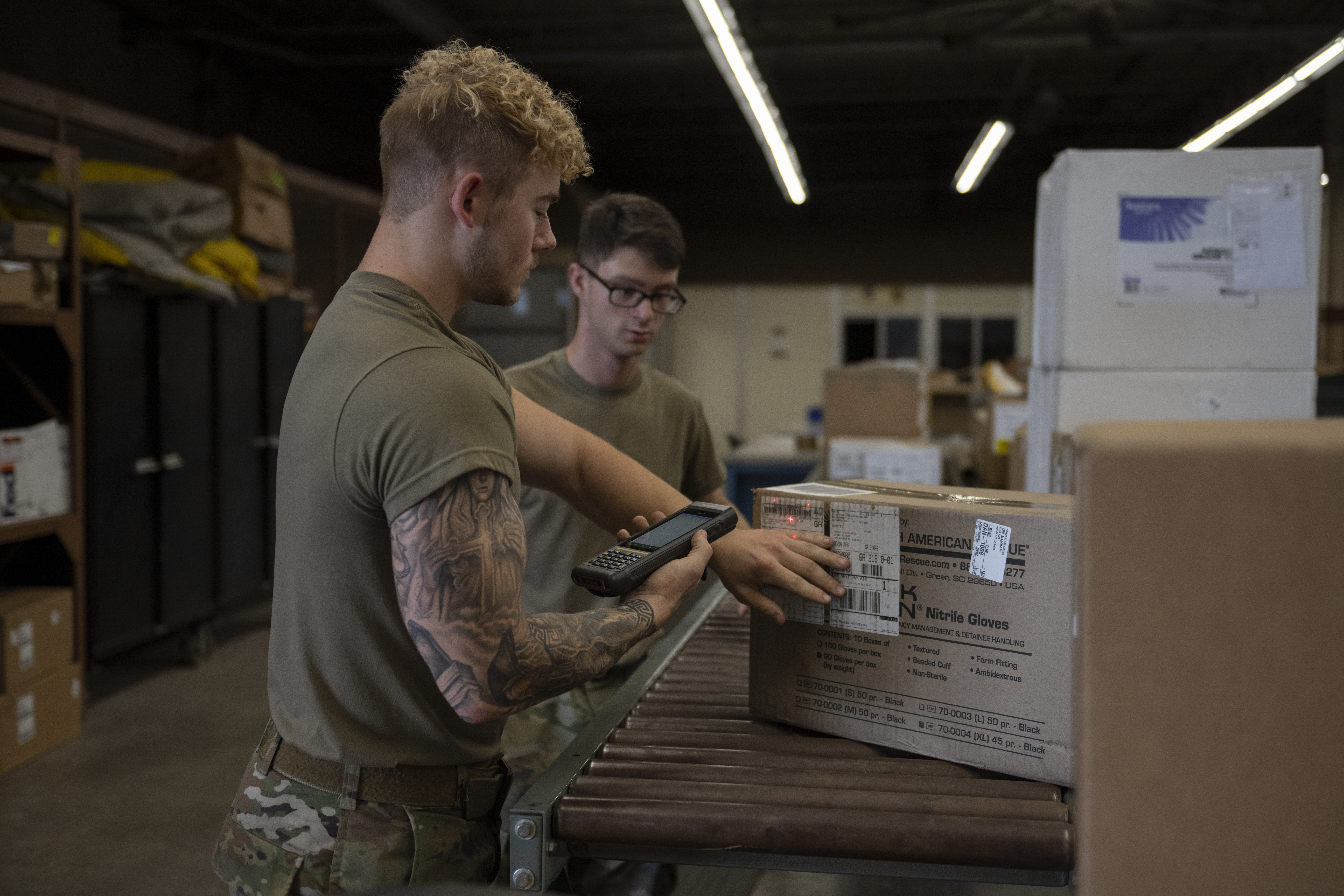 Air Force Staff Sergeant Brandon Wright,23rd Logistics Readiness Squadronnoncommissioned officer in charge ofinbound cargo, and Senior Airman AshtonLee, 23rd LRS inbound cargo technician, scanbox of cargo in warehouse at Moody Air ForceBase, Georgia, July 5, 2023 (U.S. Air Force/Rachel Coates)
